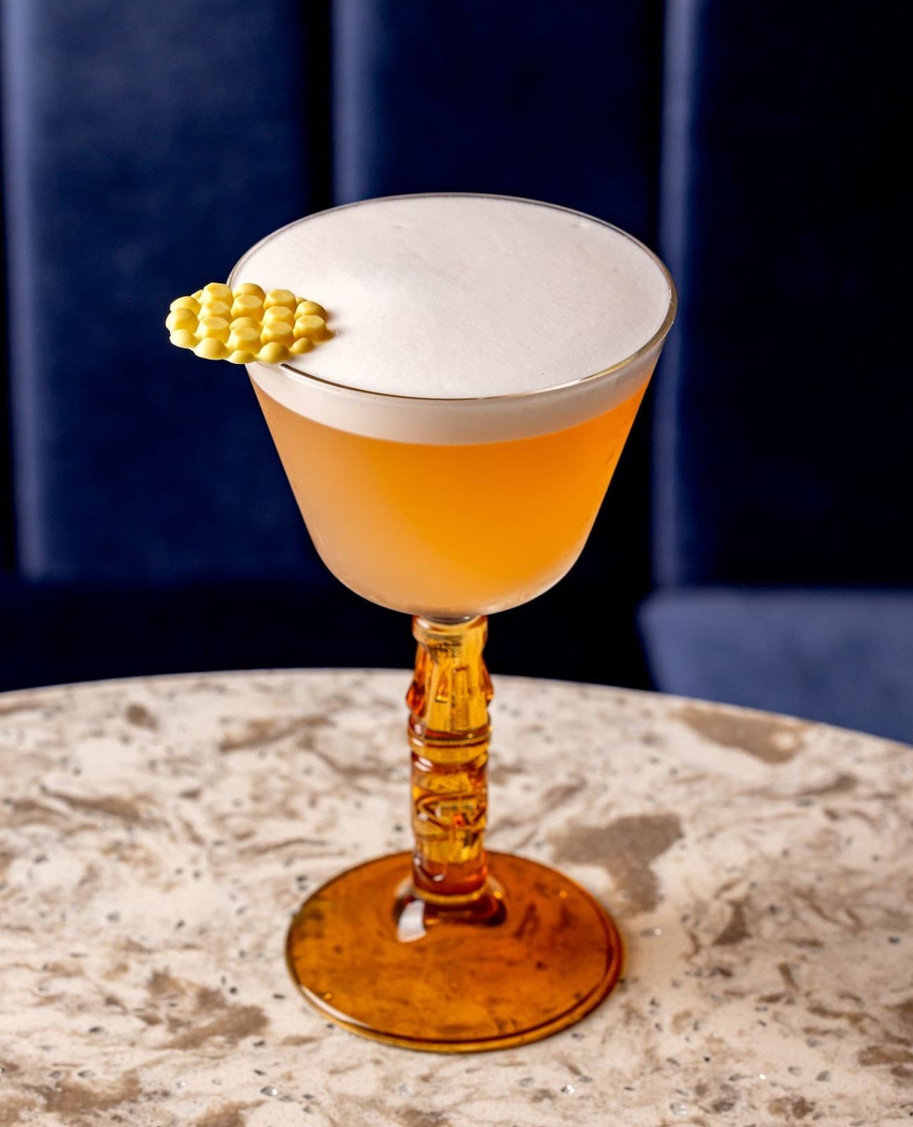 Elegant cocktail with a frothy top on a marble table in London