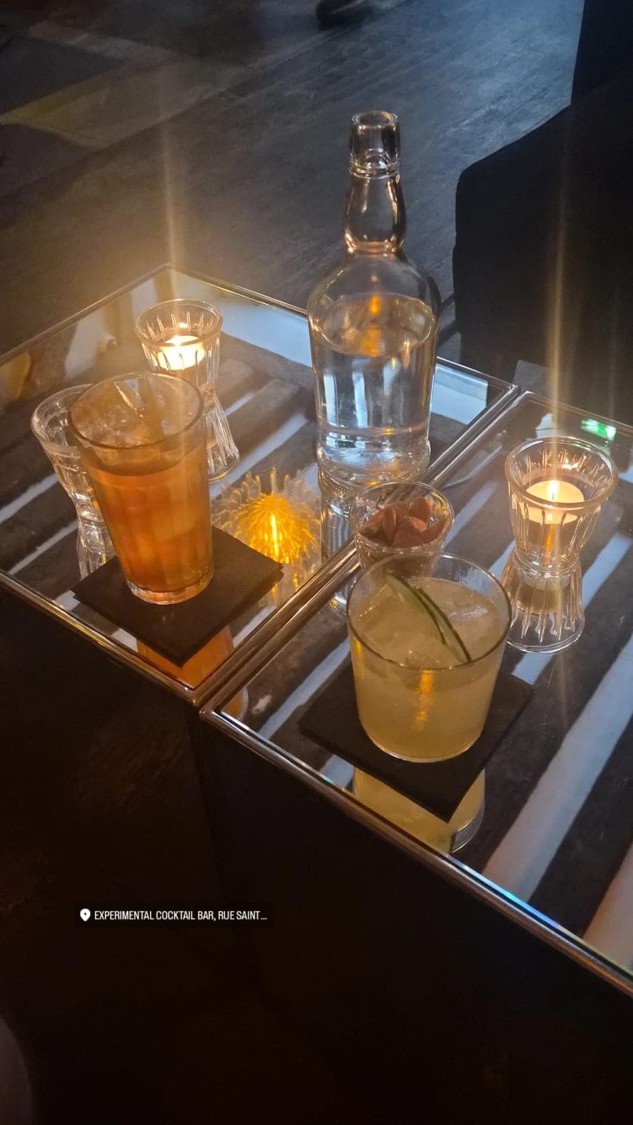 Cocktail table at Experimental Cocktail Bar with drinks and candles in Paris