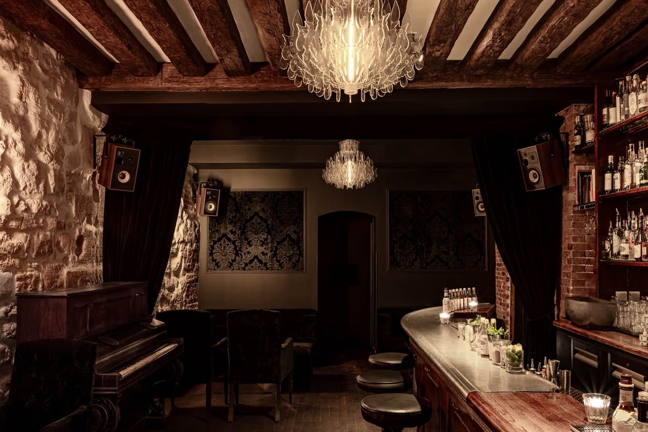 Cozy cocktail bar interior with vintage decor and a well-stocked bar counter