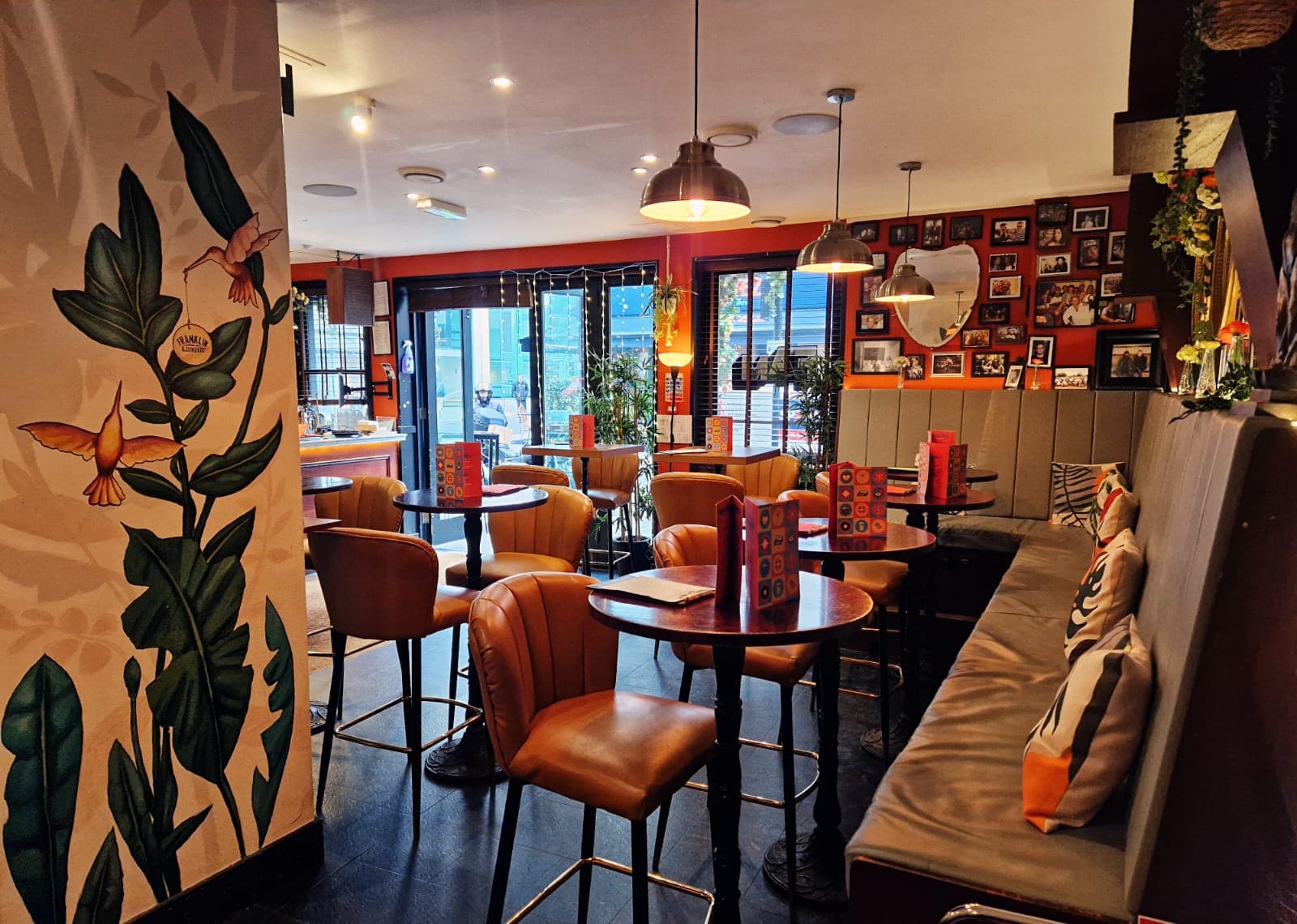 Stylish interior seating with leather chairs and wall art in a cocktail bar in London