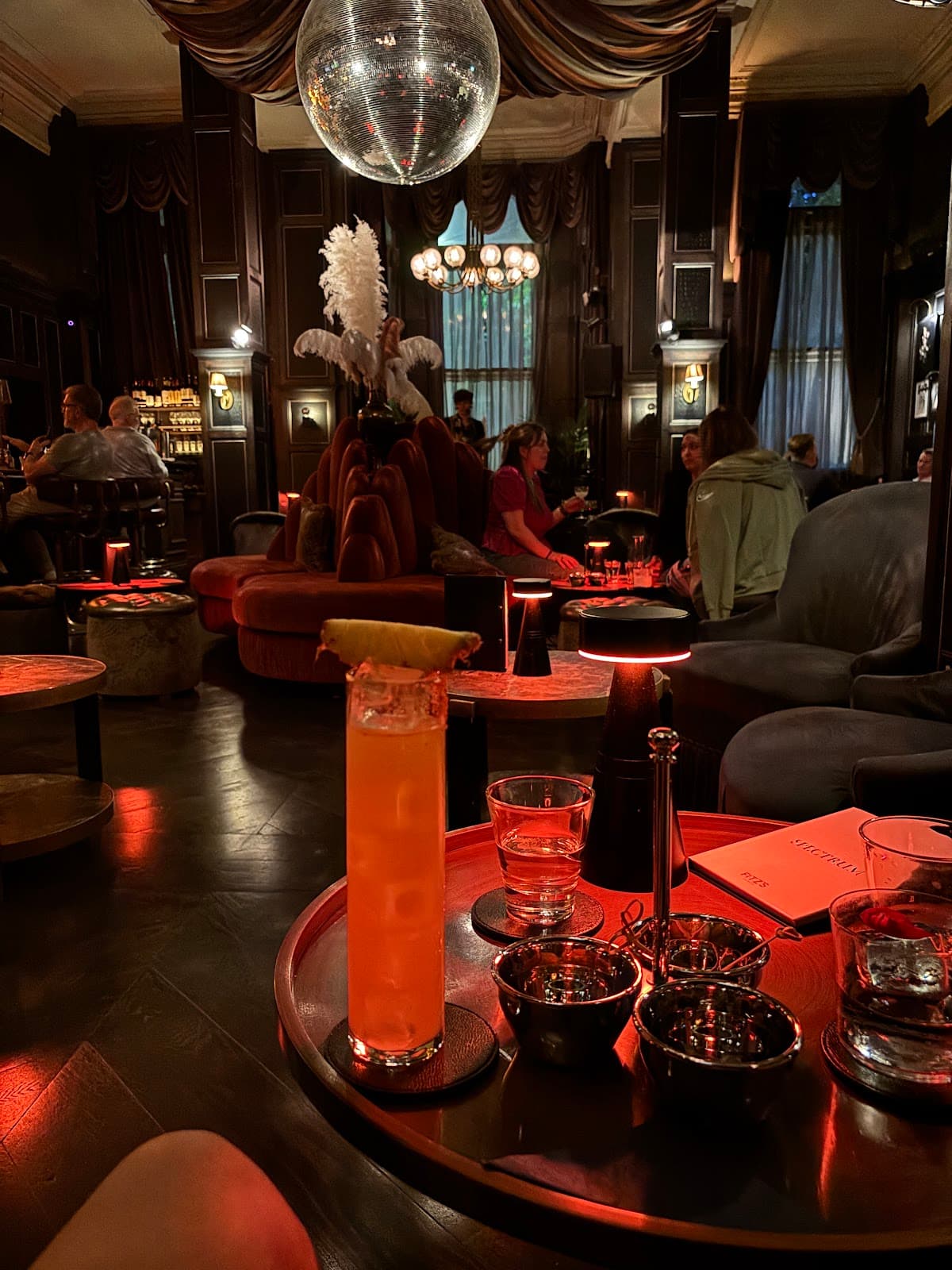 Luxurious cocktail bar interior with dim lighting and ornate decor. in London