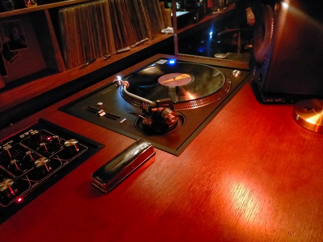 Cozy bar with a vintage turntable and records on display in Paris