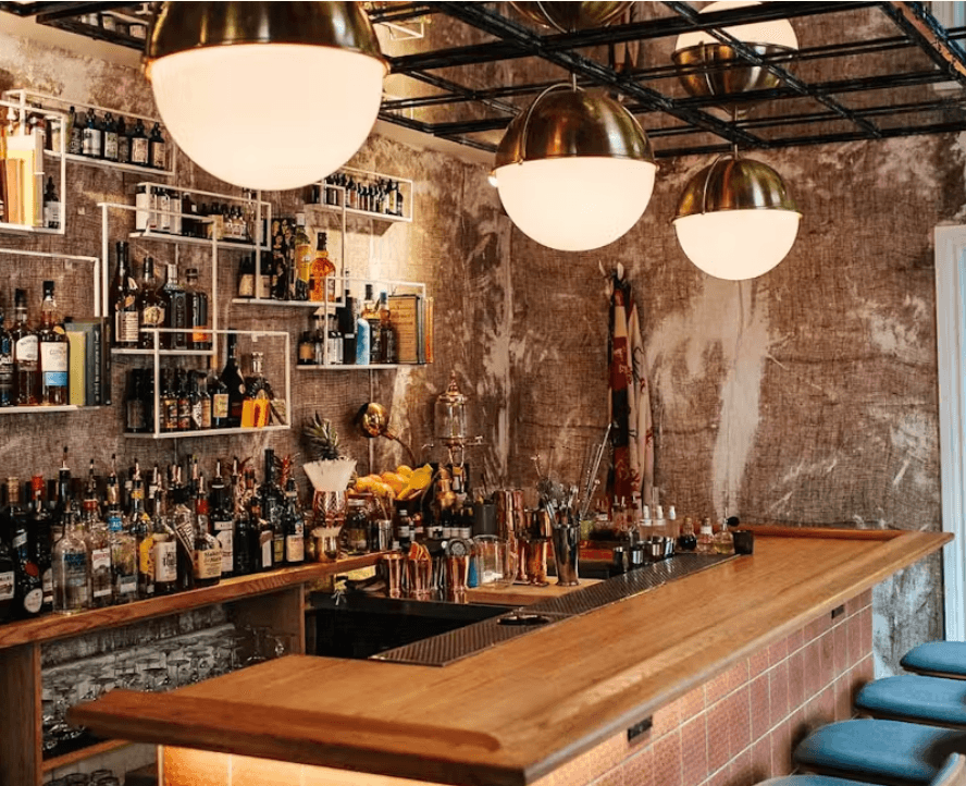 Stylish bar interior with hanging lamps and stocked shelves in Toronto