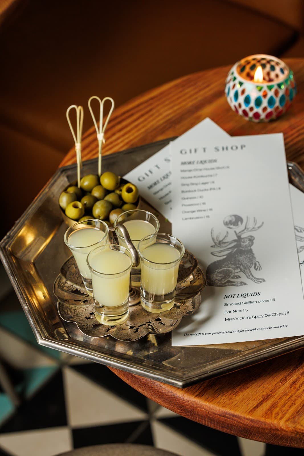 Tray with lime cocktails and olives on a wooden table in a bar in Toronto