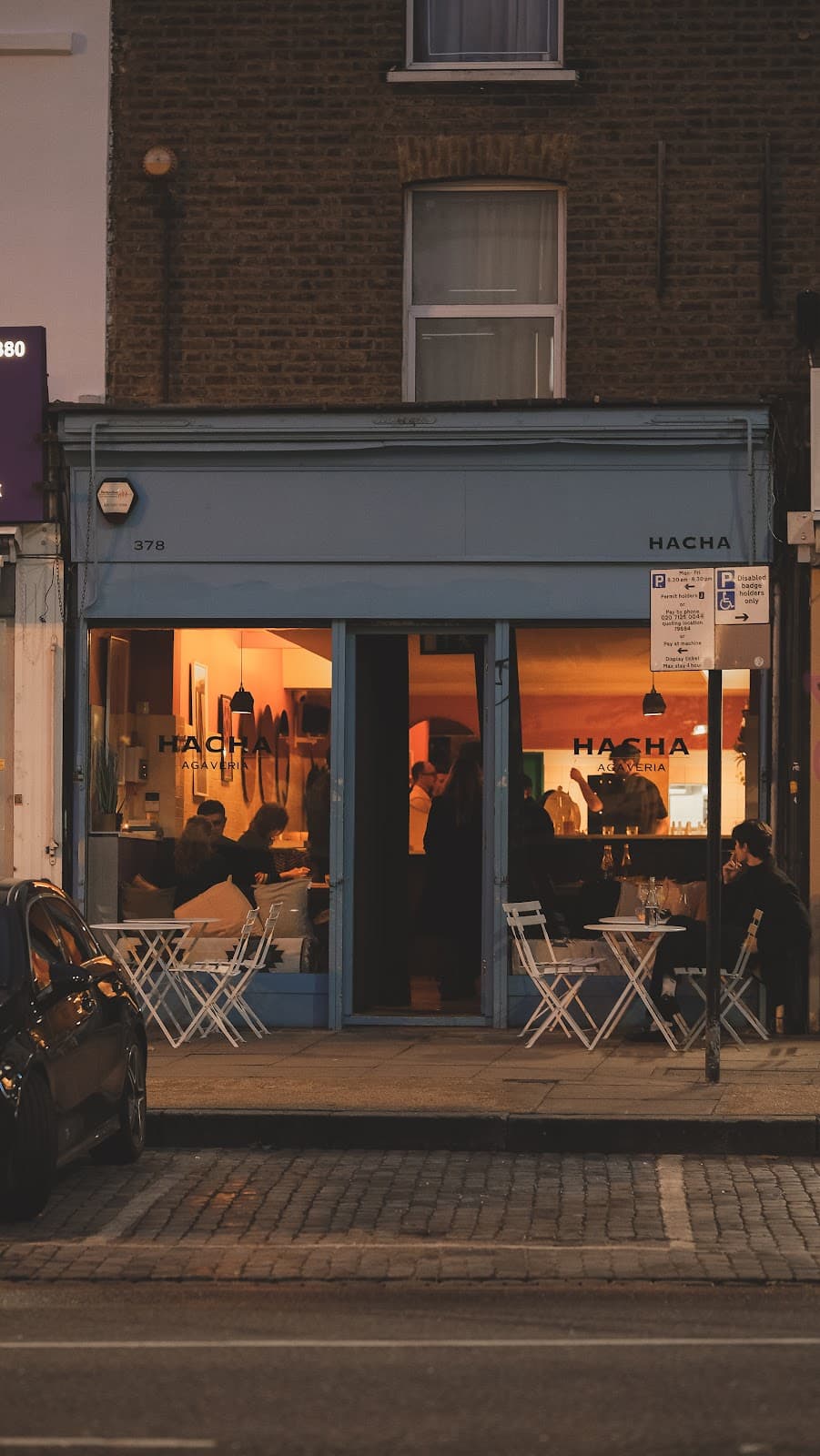 Exterior of Hacha Agaveria with outdoor seating and warm lighting in London