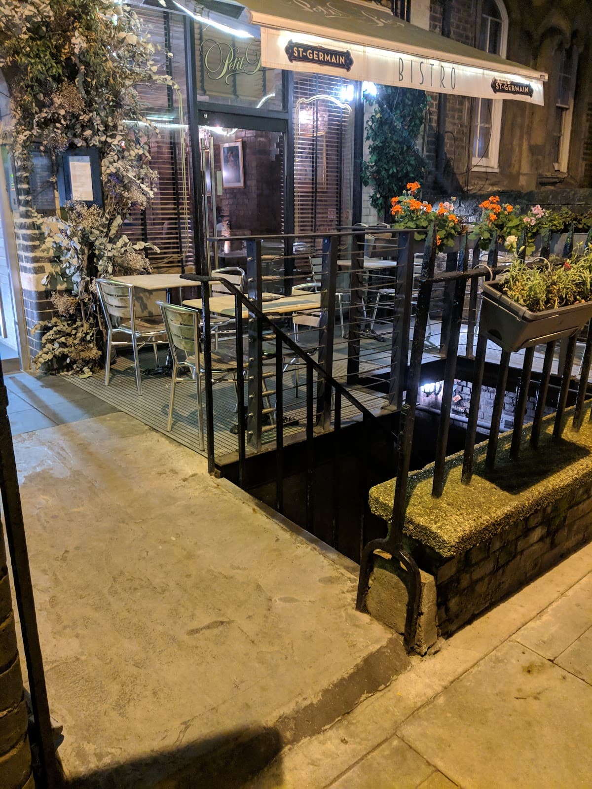 Outdoor seating with awning at Petit Bistro in London