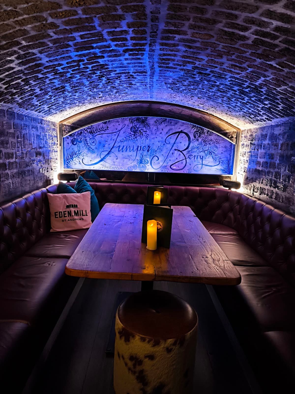Cozy interior with arched brick ceiling and leather seating at Juniper Berry in Edinburgh