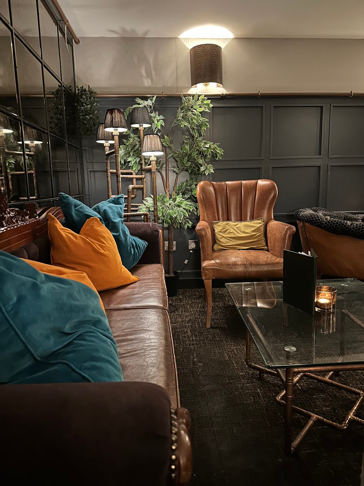 Cozy interior with leather seating, colorful cushions, and warm lighting in Edinburgh