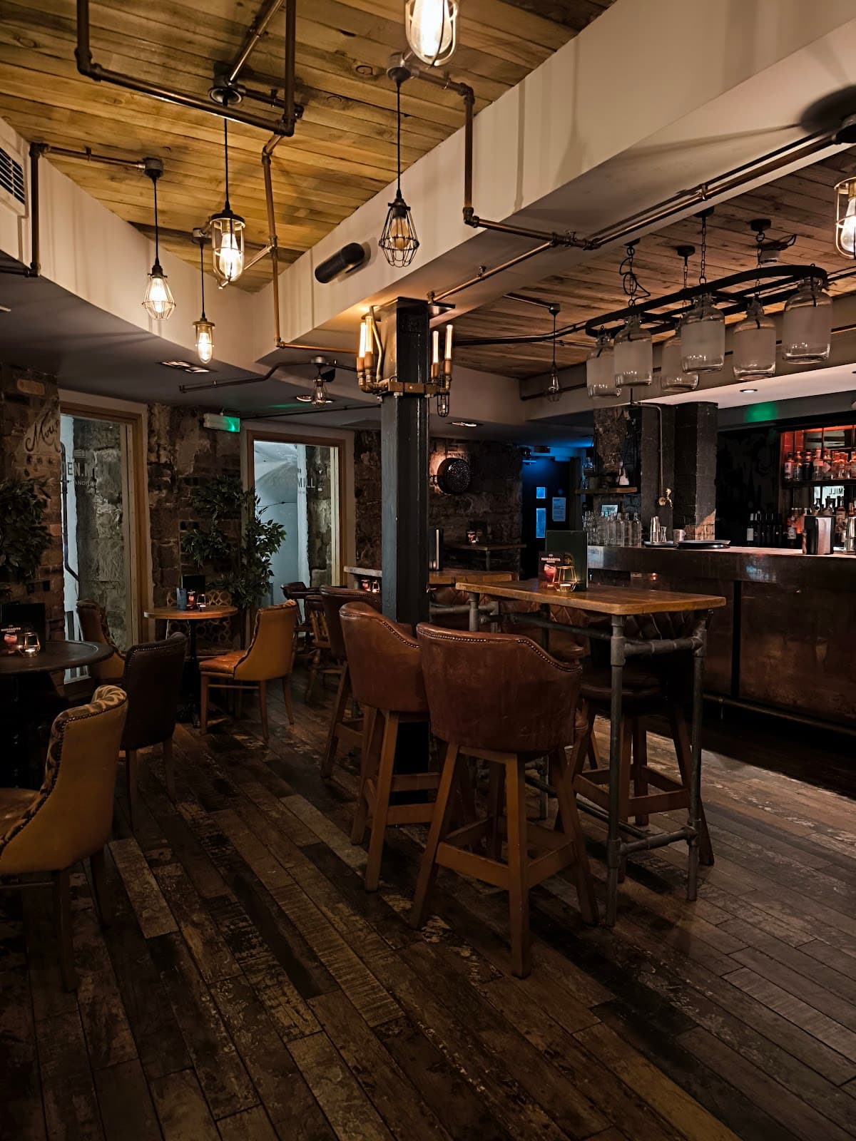 Cozy bar interior with wooden furniture and vintage lighting
