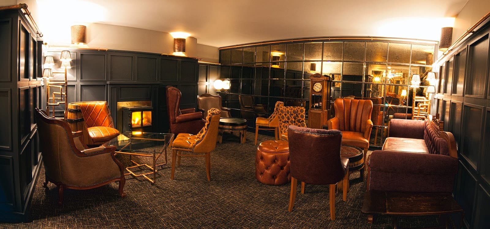 Luxurious interior with leather chairs and a fireplace in a cocktail bar in Edinburgh