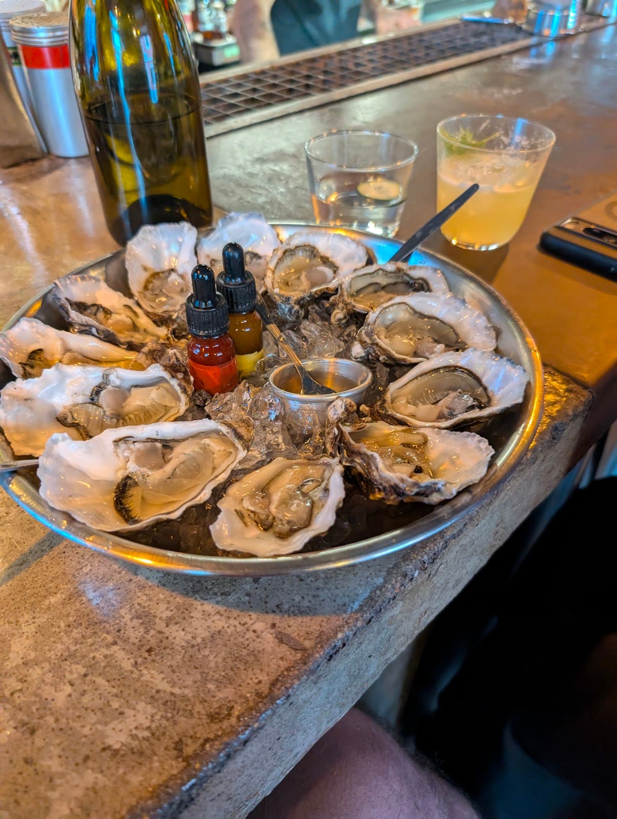 Tray of oysters with hot sauce on a bar counter in Lisboa