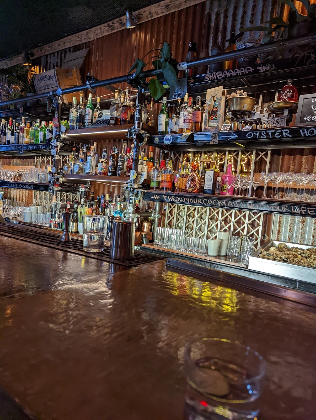 Close-up of a well-stocked bar with various liquor bottles and glassware