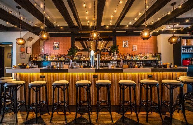 Stylish bar with glowing lights and high stools