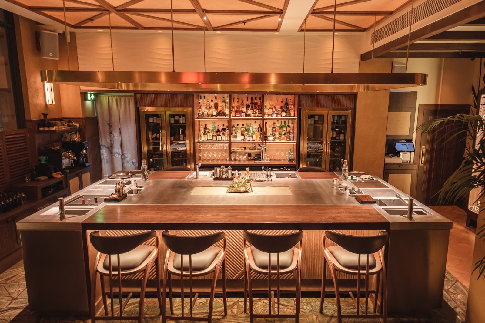 Elegant bar interior with a well-stocked back shelf and sleek counter setup