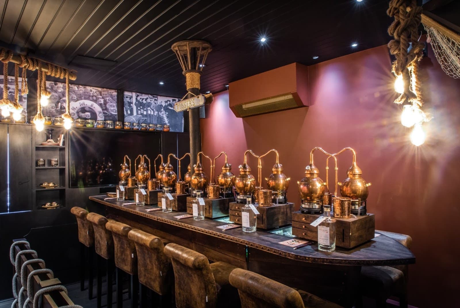 Stylish bar interior with copper stills and leather seating