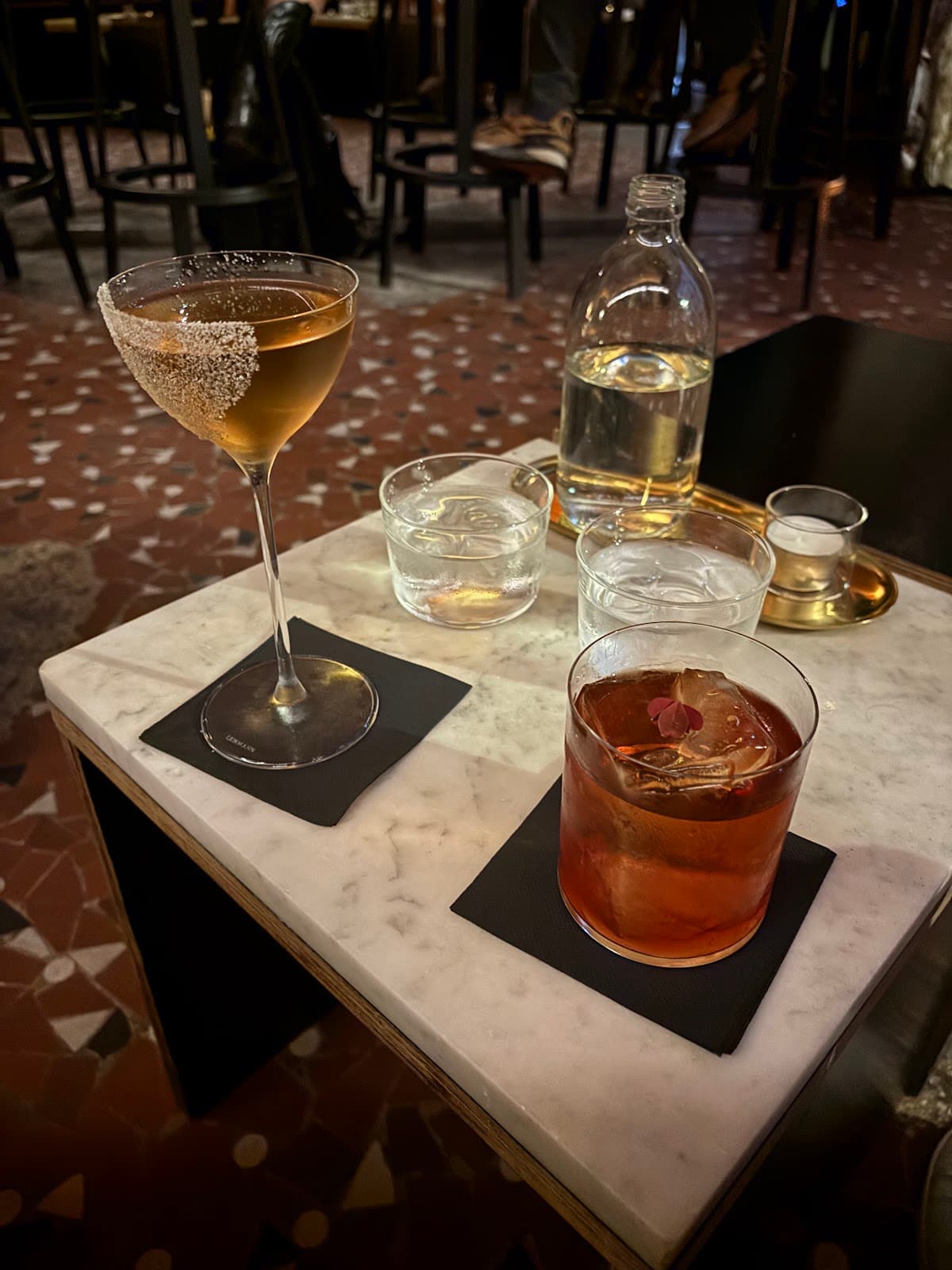 Close-up of cocktails on a marble table at a cocktail bar in Paris