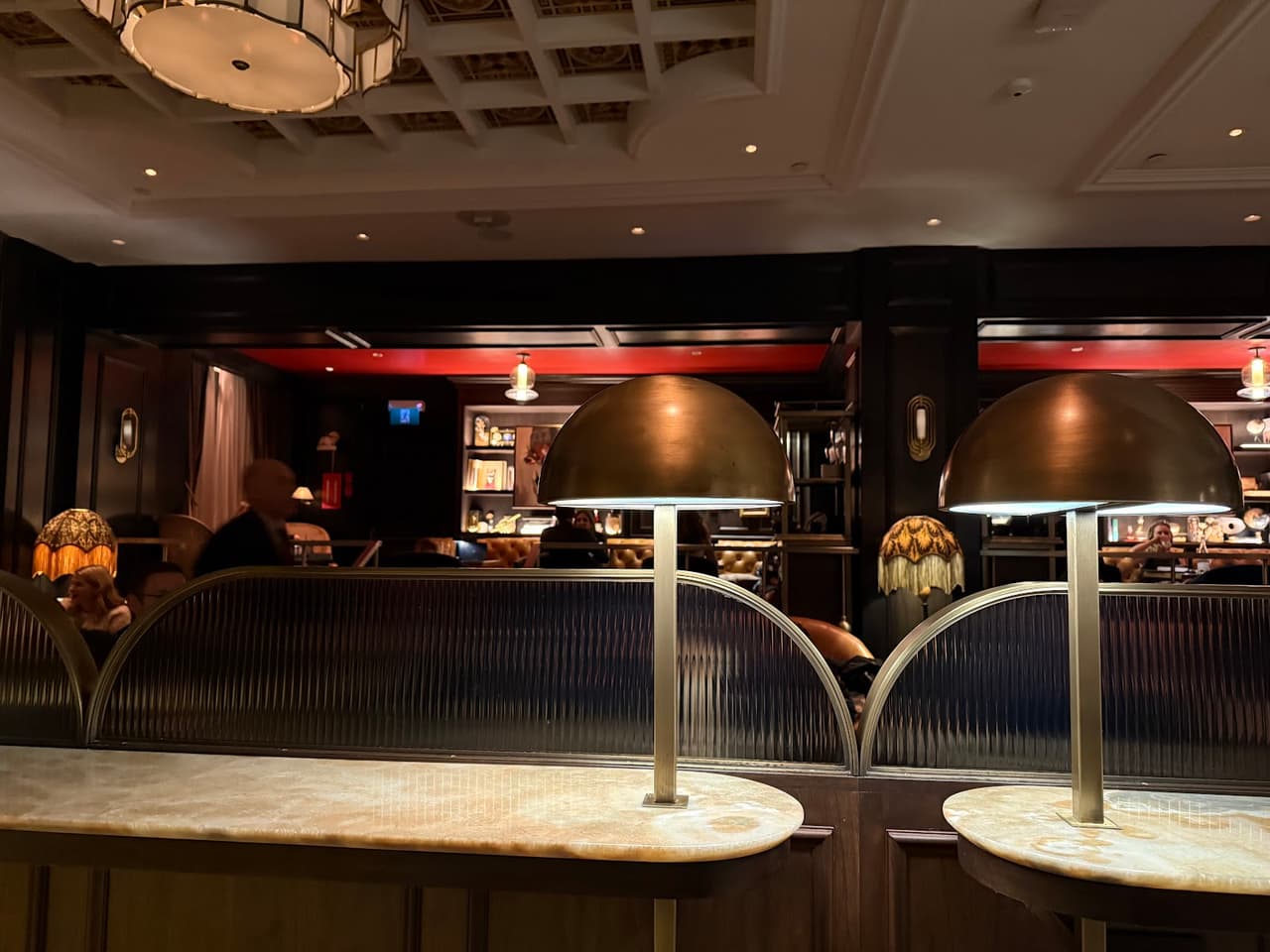 Dimly lit interior with brass lamps and cozy seating area in Toronto
