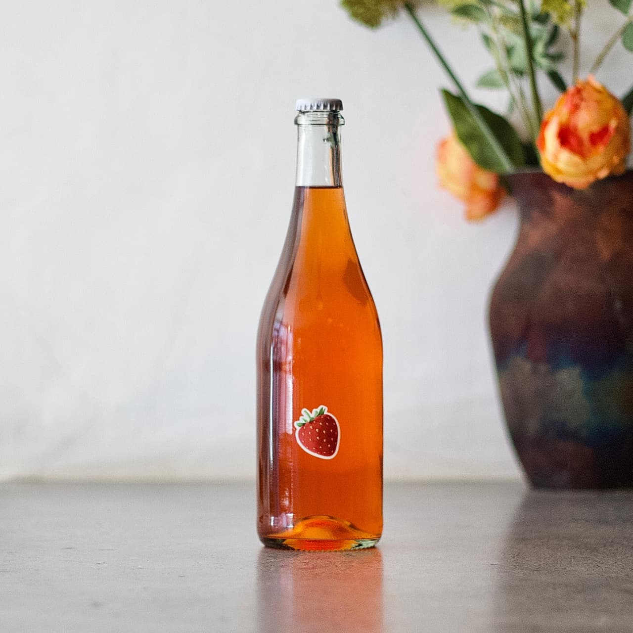 Amber bottle with strawberry label on a bar counter in London