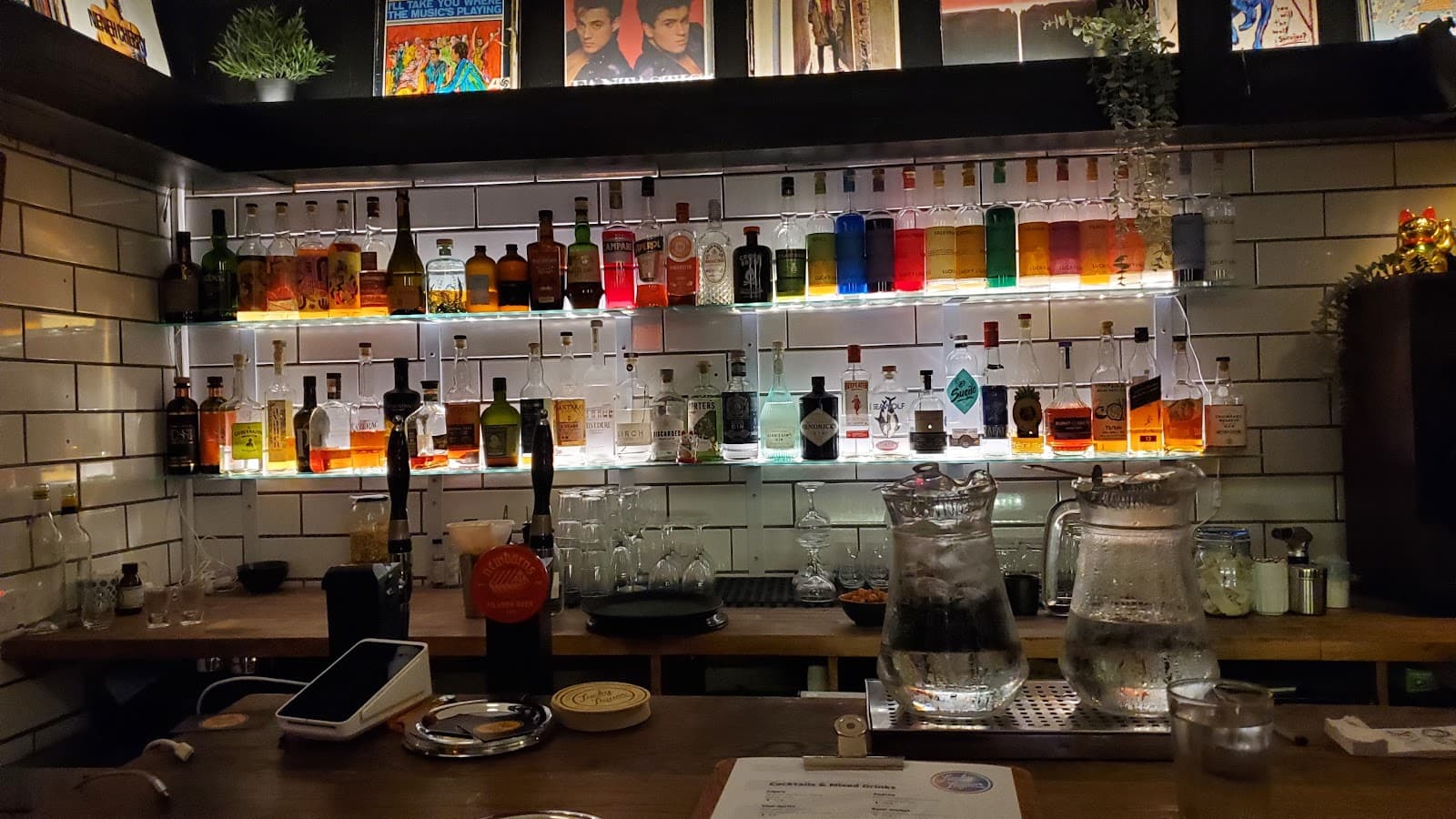 Well-lit bar counter with assorted liquor bottles on display in Edinburgh