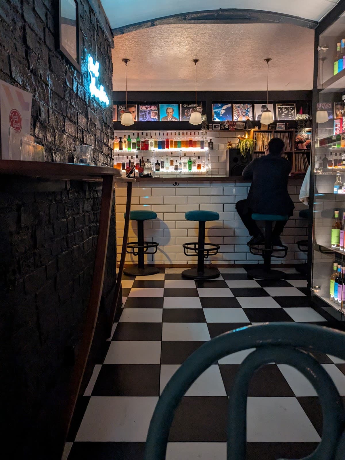 Cozy bar with checkered floor and neon sign ambiance in Edinburgh