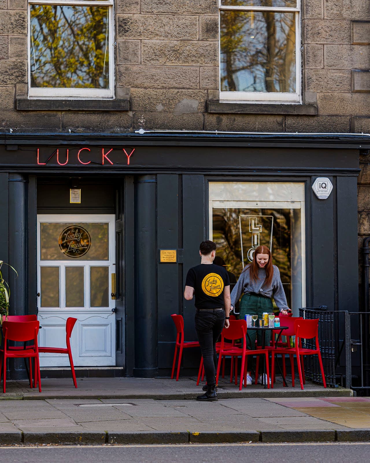 Exterior of Lucky venue with red lettering and outdoor seating in Edinburgh