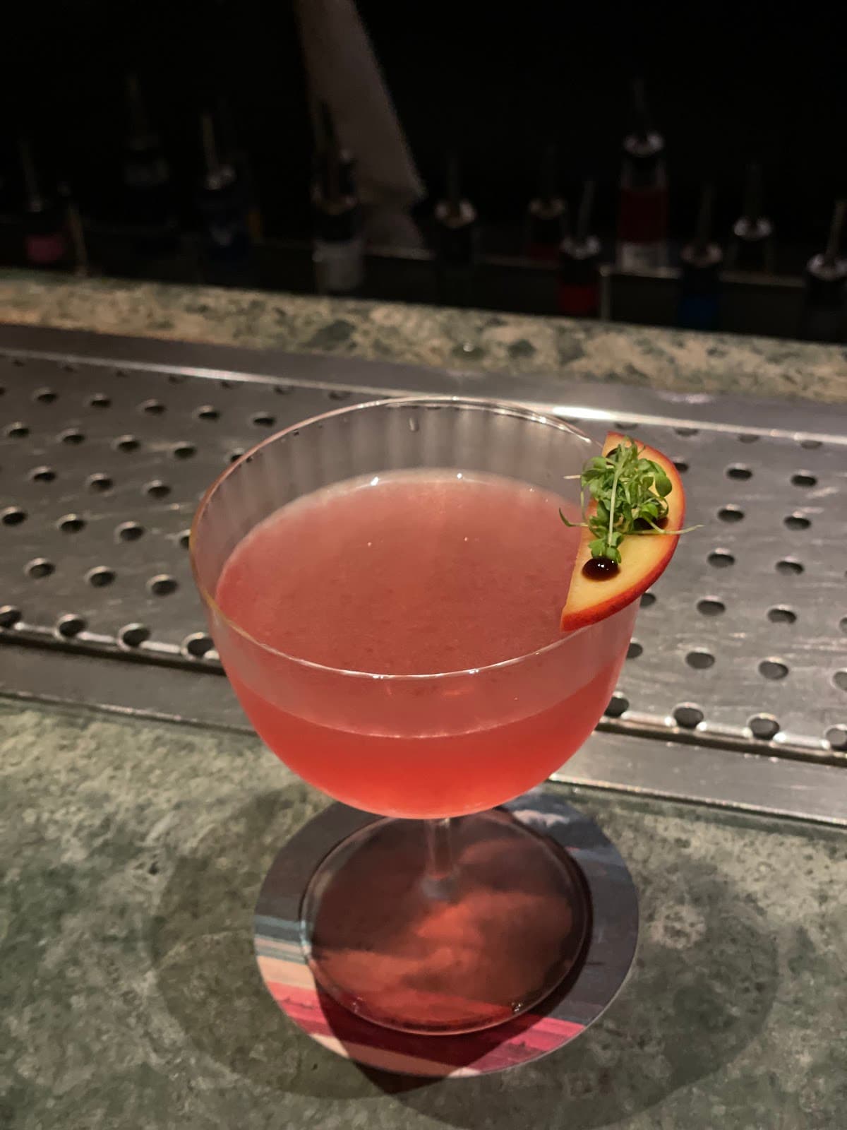 Elegant cocktail with garnish on a bar counter in London