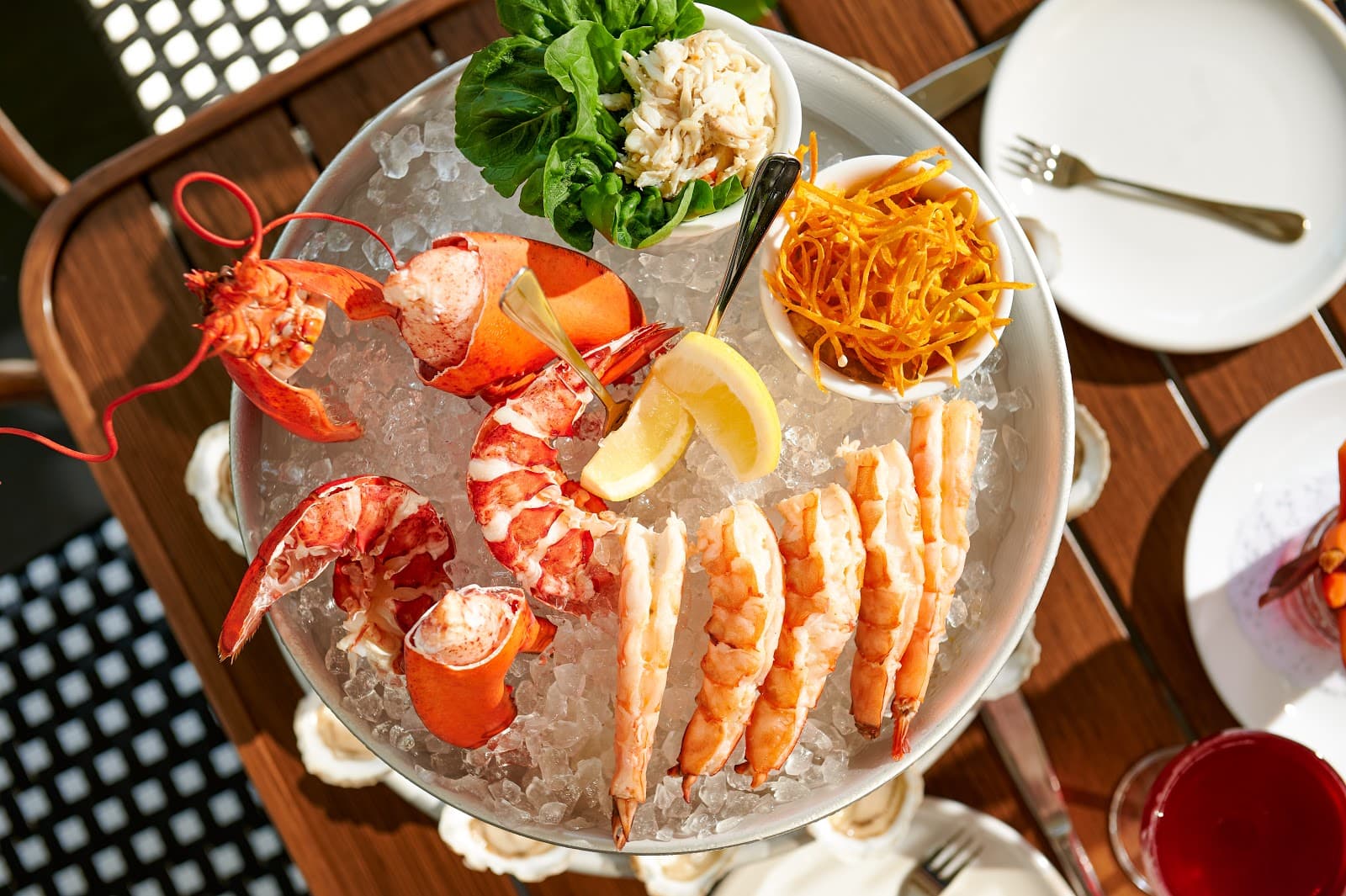 Seafood platter with lobster and shrimp on ice, served with cocktail. in New York