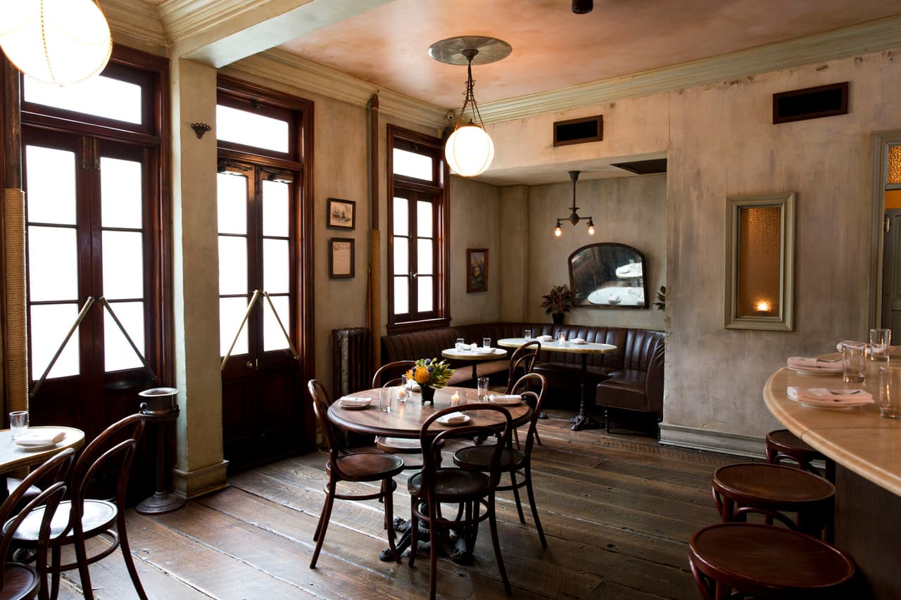 Cozy interior with wooden floors, round tables, and vintage decor in New York