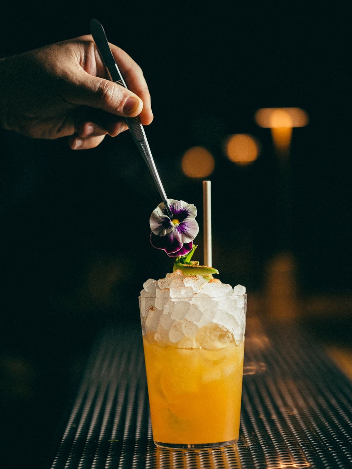 Close-up of a cocktail with garnishing in a dimly lit bar in Lisboa