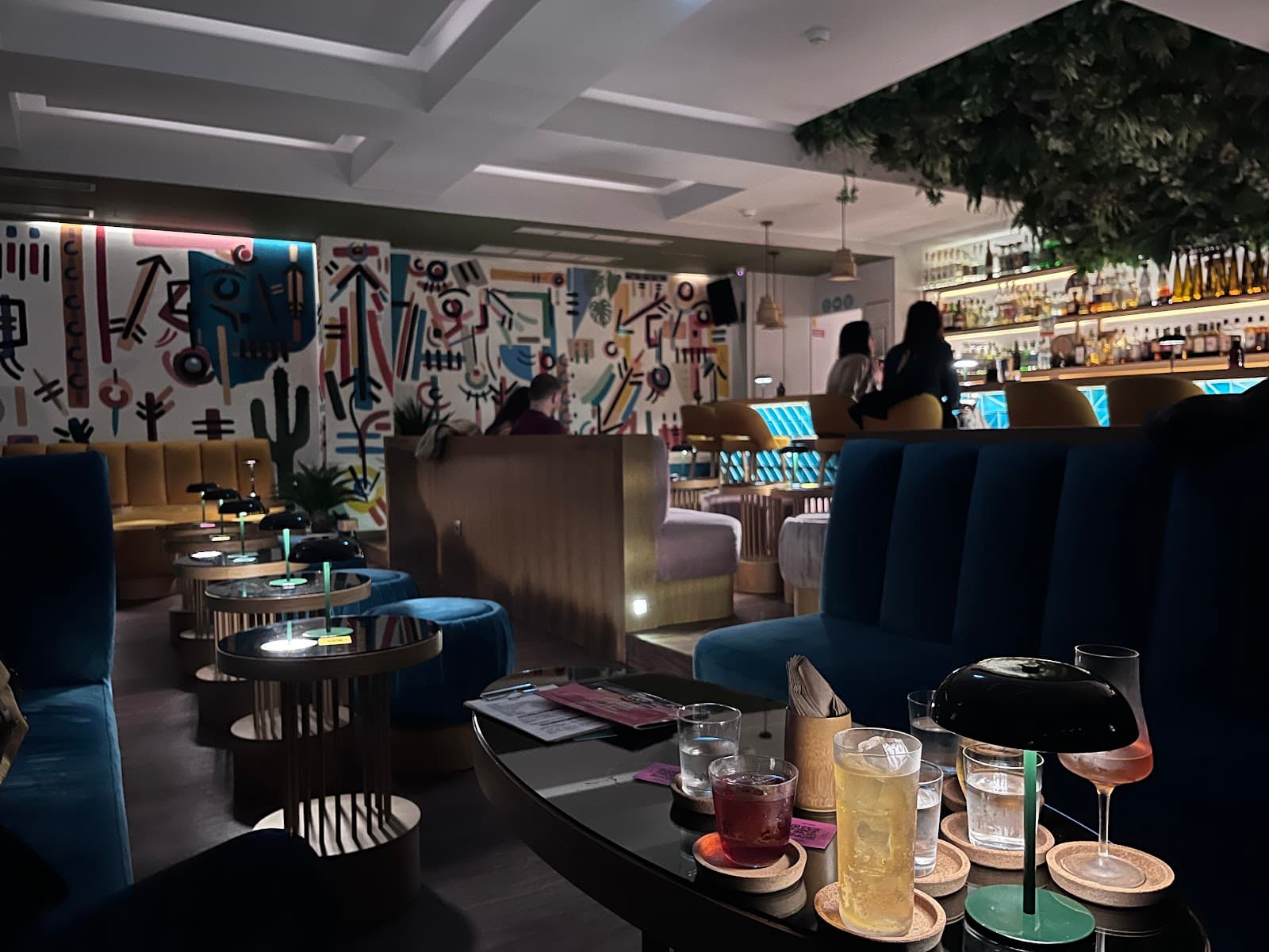Stylish bar interior with colorful wall art and cozy seating in Lisboa