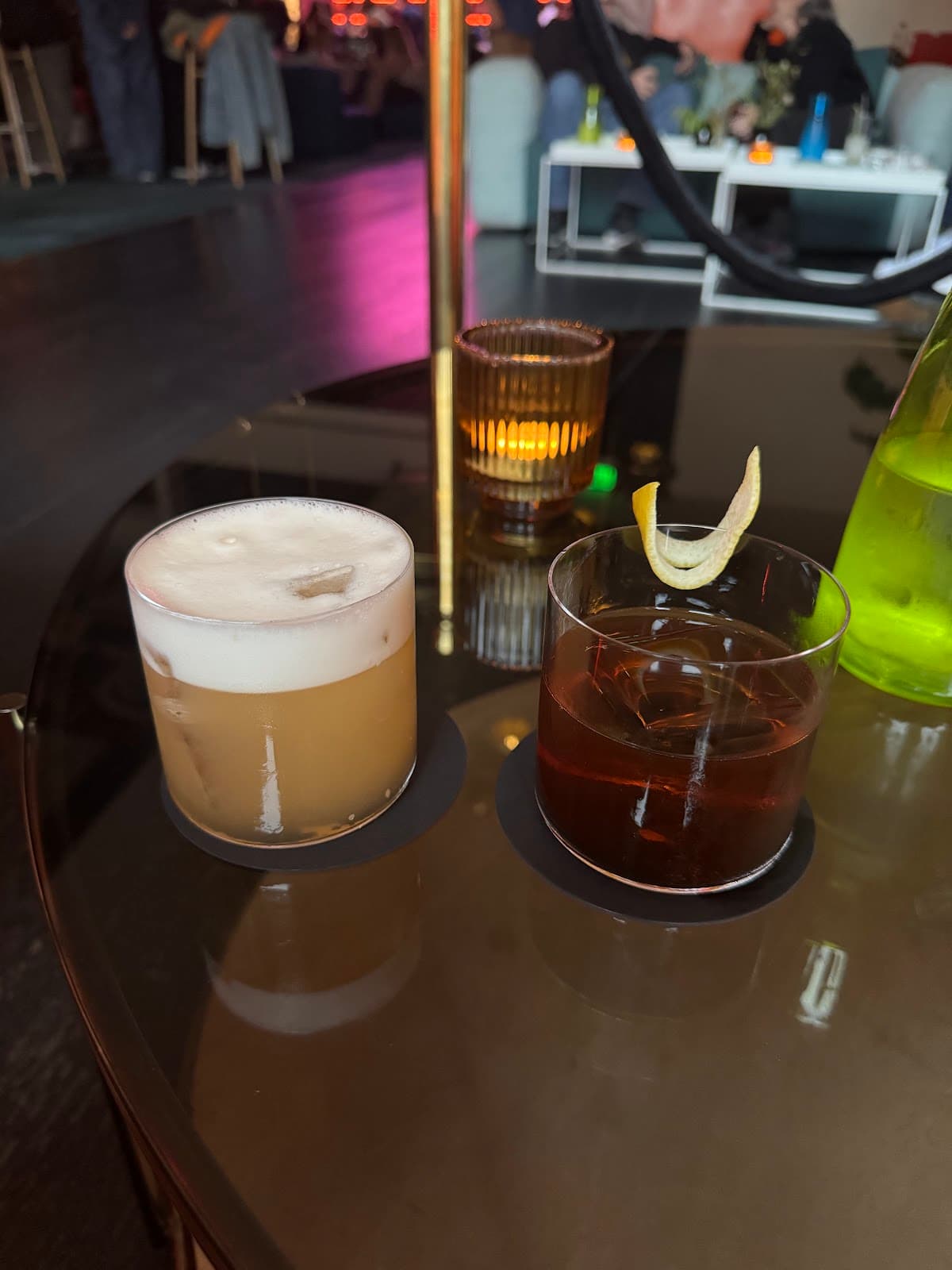 Close-up of two cocktails on a table in a dimly lit bar setting in San Francisco