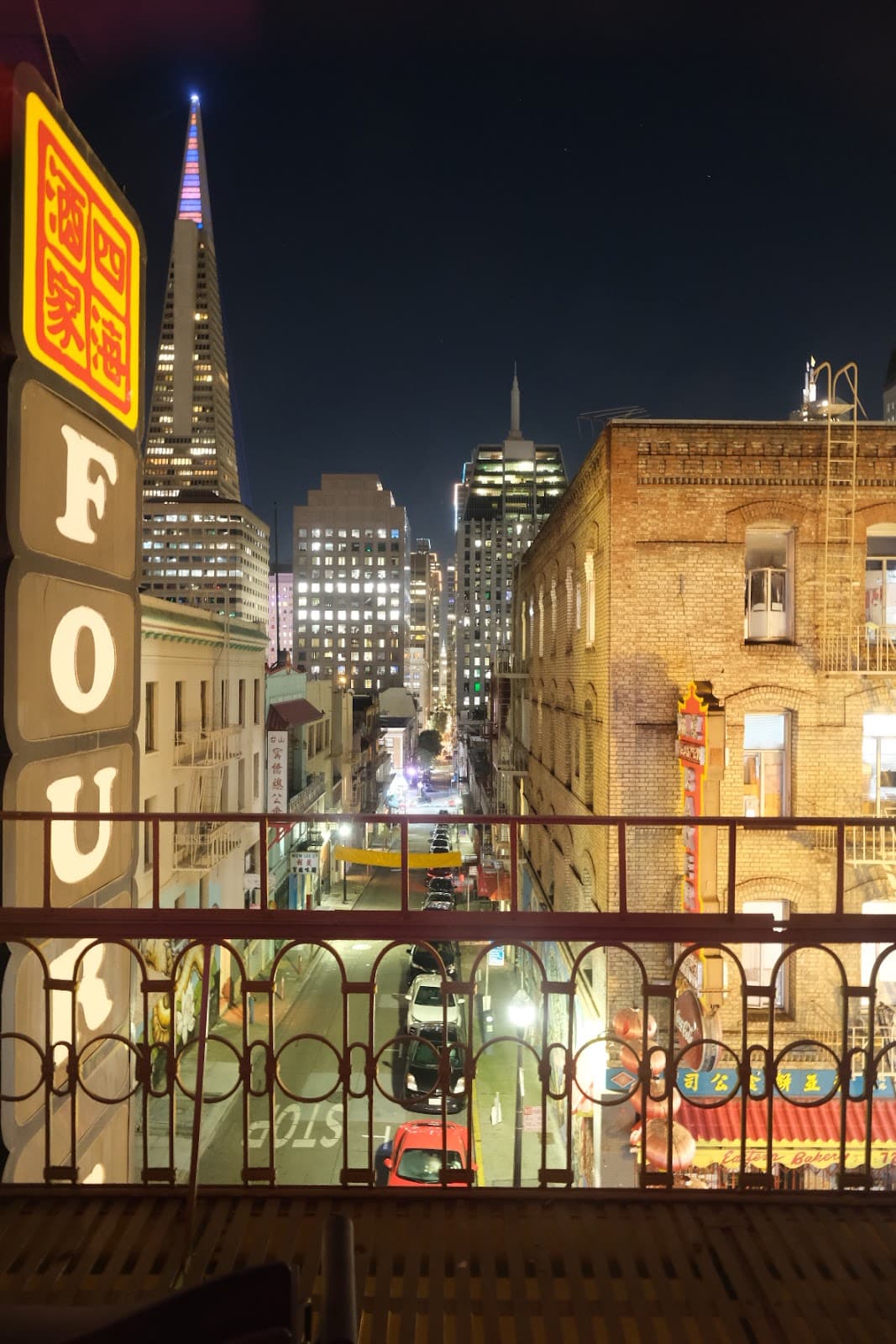 Night cityscape view from balcony with neon signs and skyscrapers in San Francisco