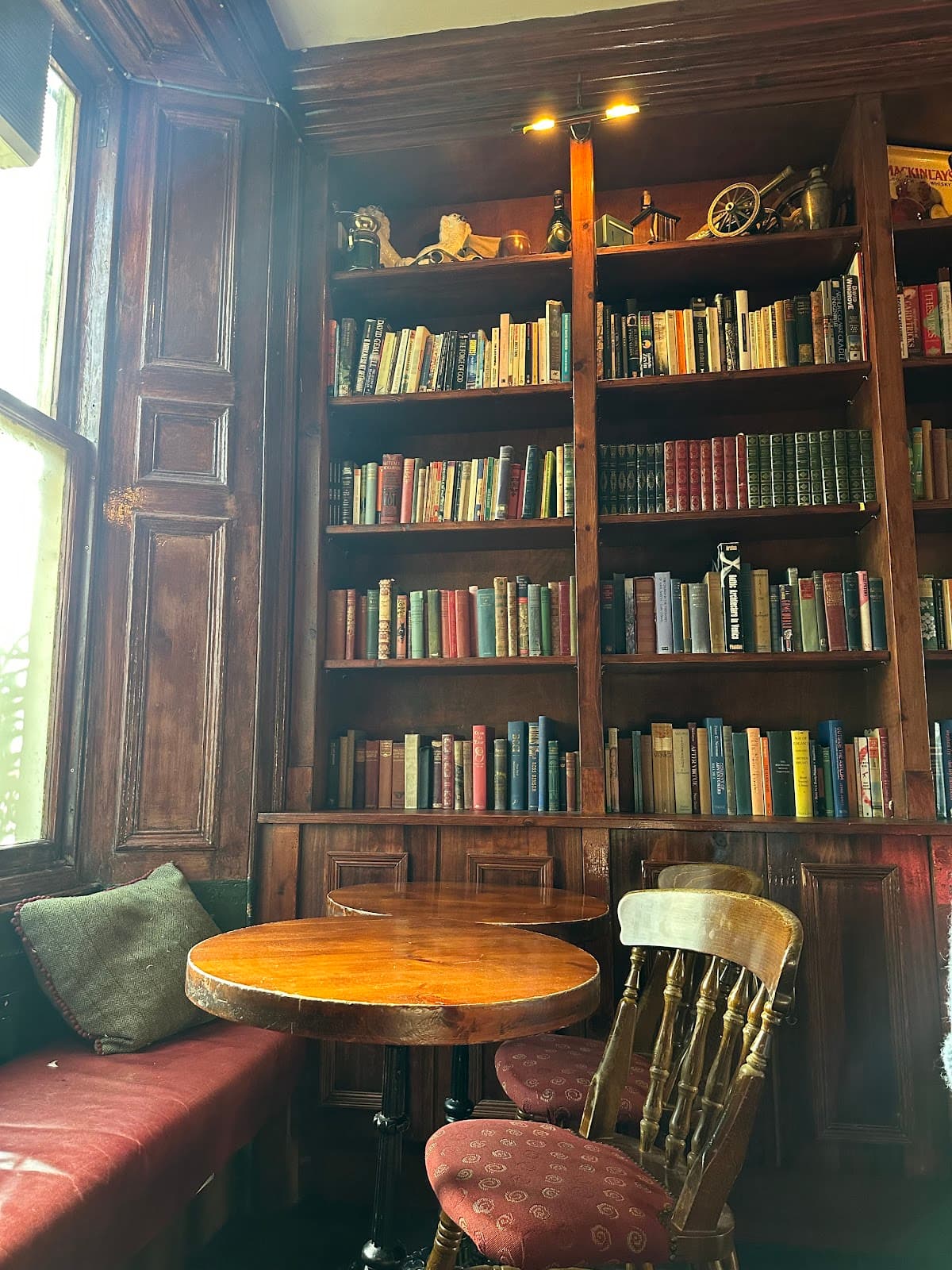 Cozy library-style interior with wooden tables and bookshelves in Edinburgh