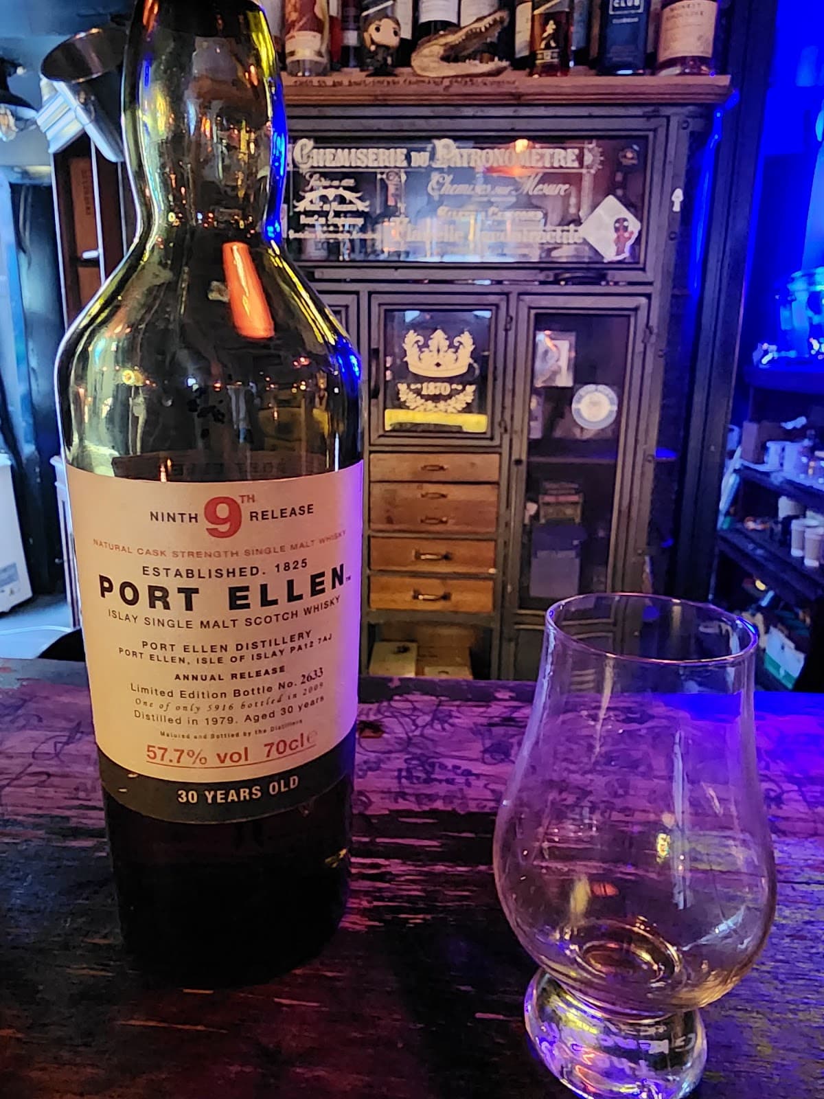 Whiskey bottle and glass on a bar with vintage decor in Edinburgh