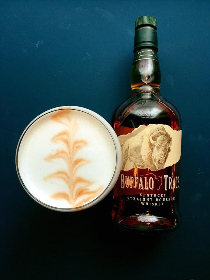 Buffalo Trace bottle beside a cocktail with foam art on dark background in Edinburgh