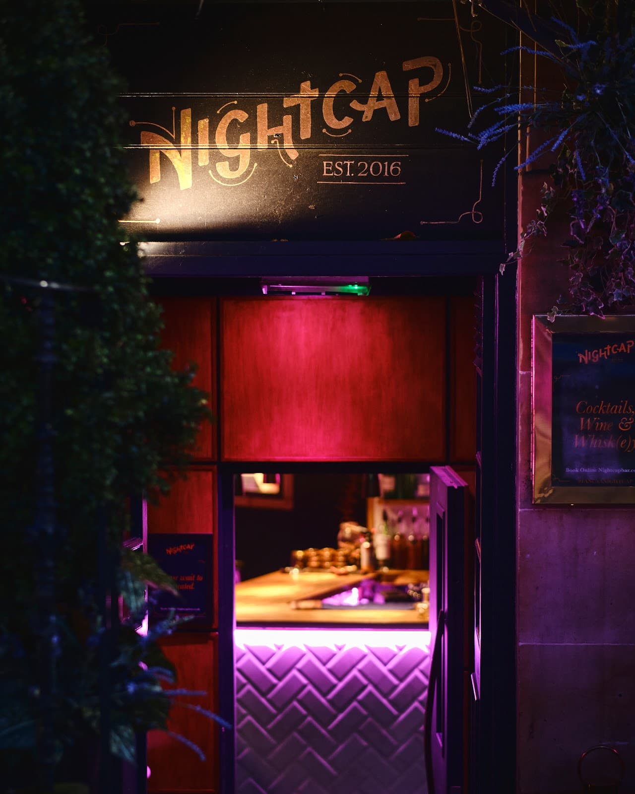 Entrance to Nightcap bar with illuminated doorway and signage in Edinburgh