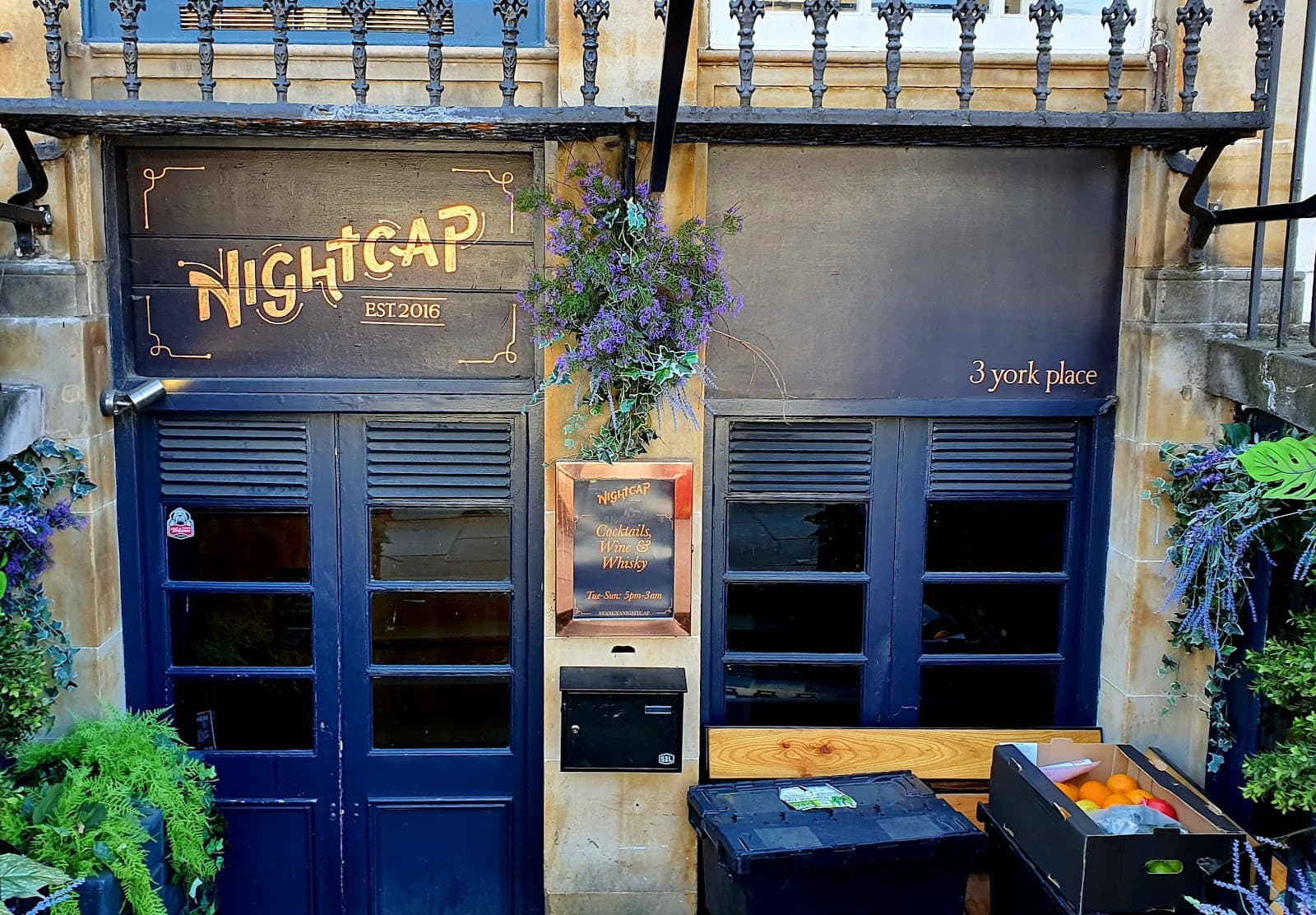 Entrance of Nightcap at 3 York Place with decorative plants in Edinburgh