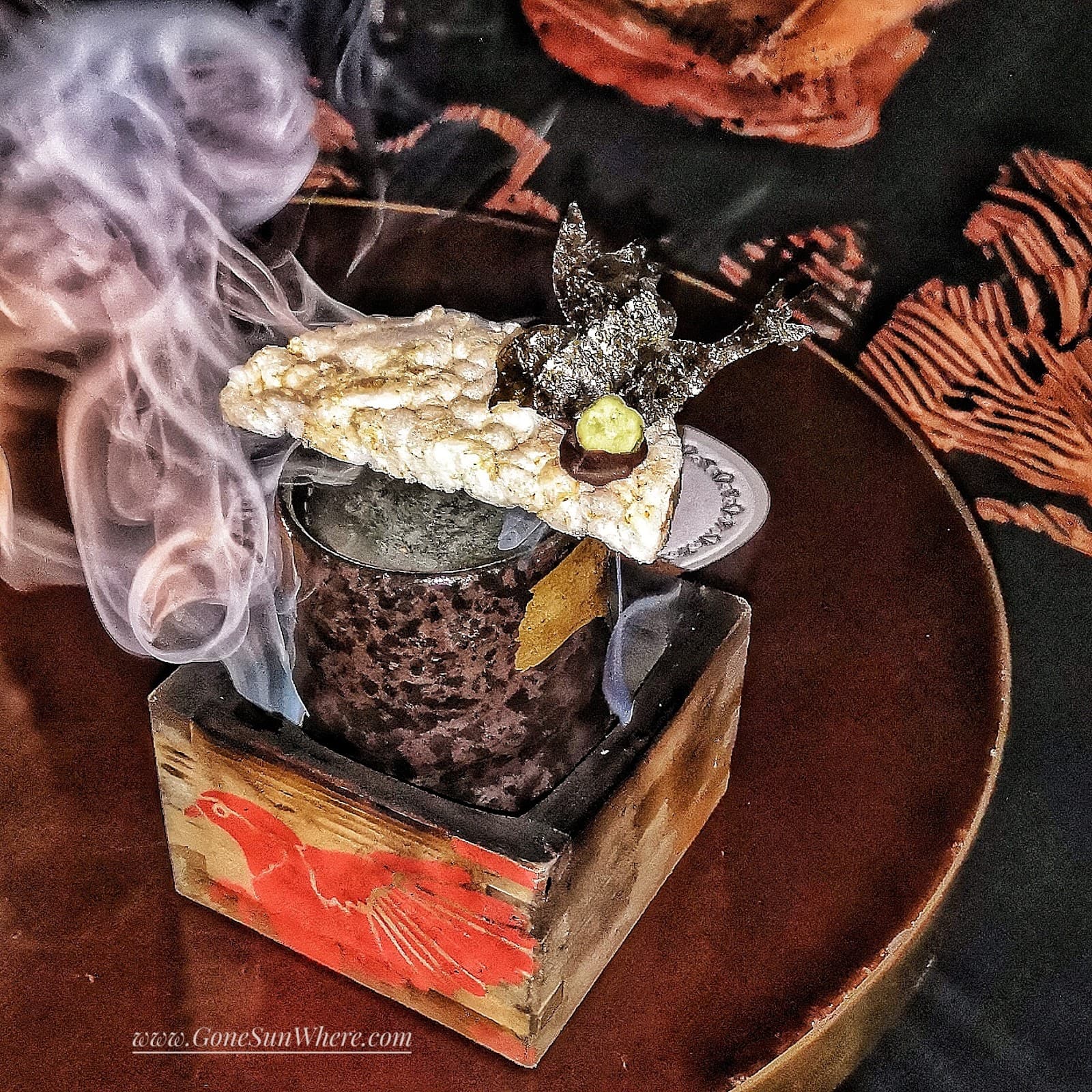 Decorative cocktail with smoke, served in a box with artistic design in London