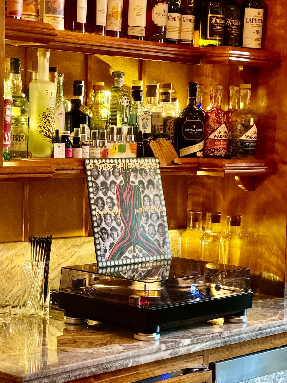 Bar counter with bottles and a turntable in London