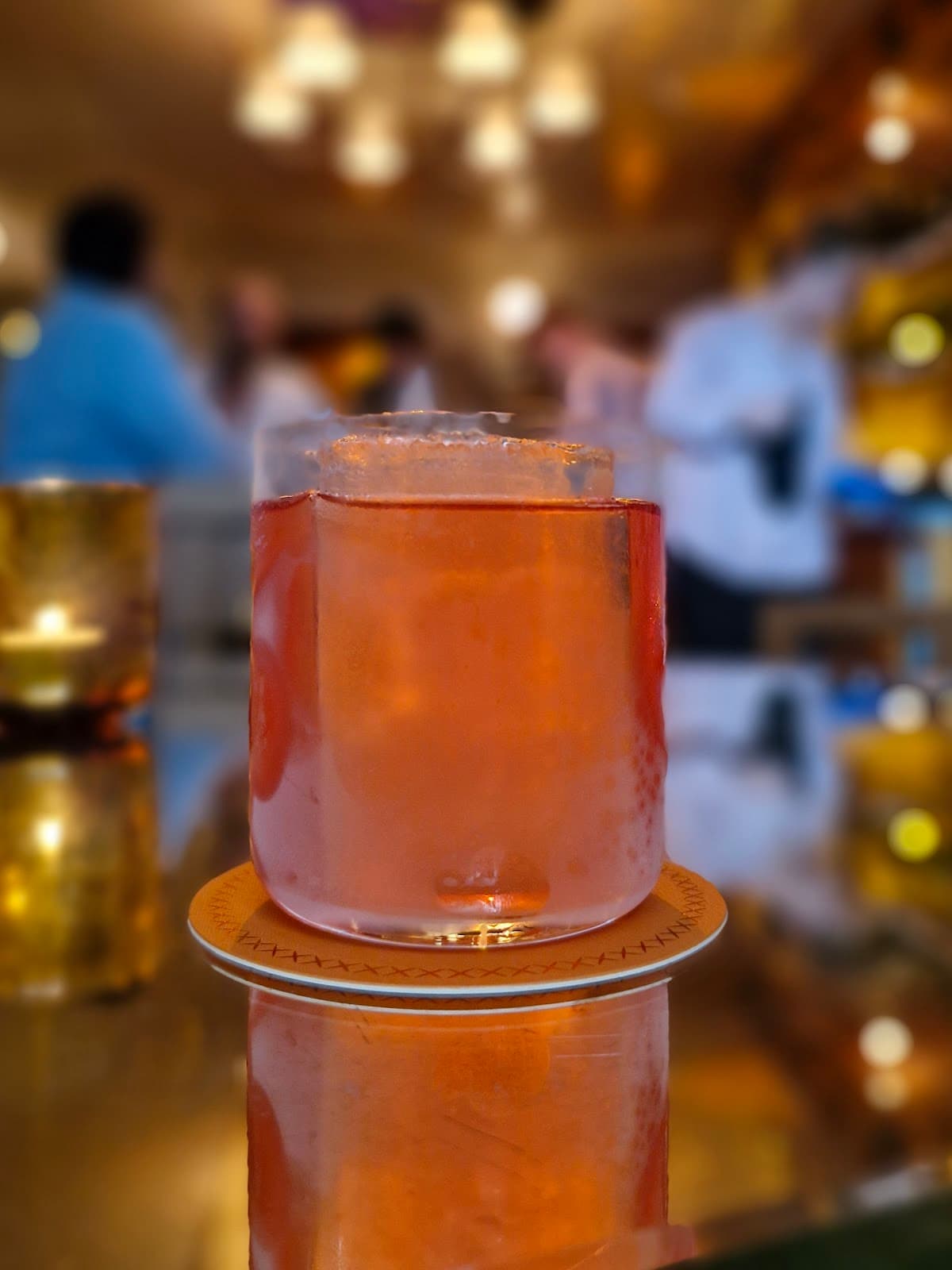 Orange cocktail on a reflective surface with blurred background in London