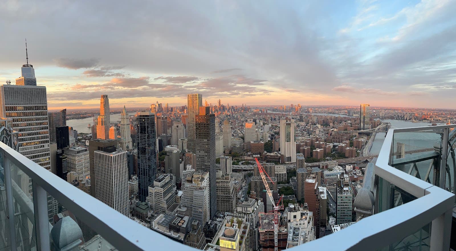 City skyline viewed from a rooftop with a sunset backdrop in New York