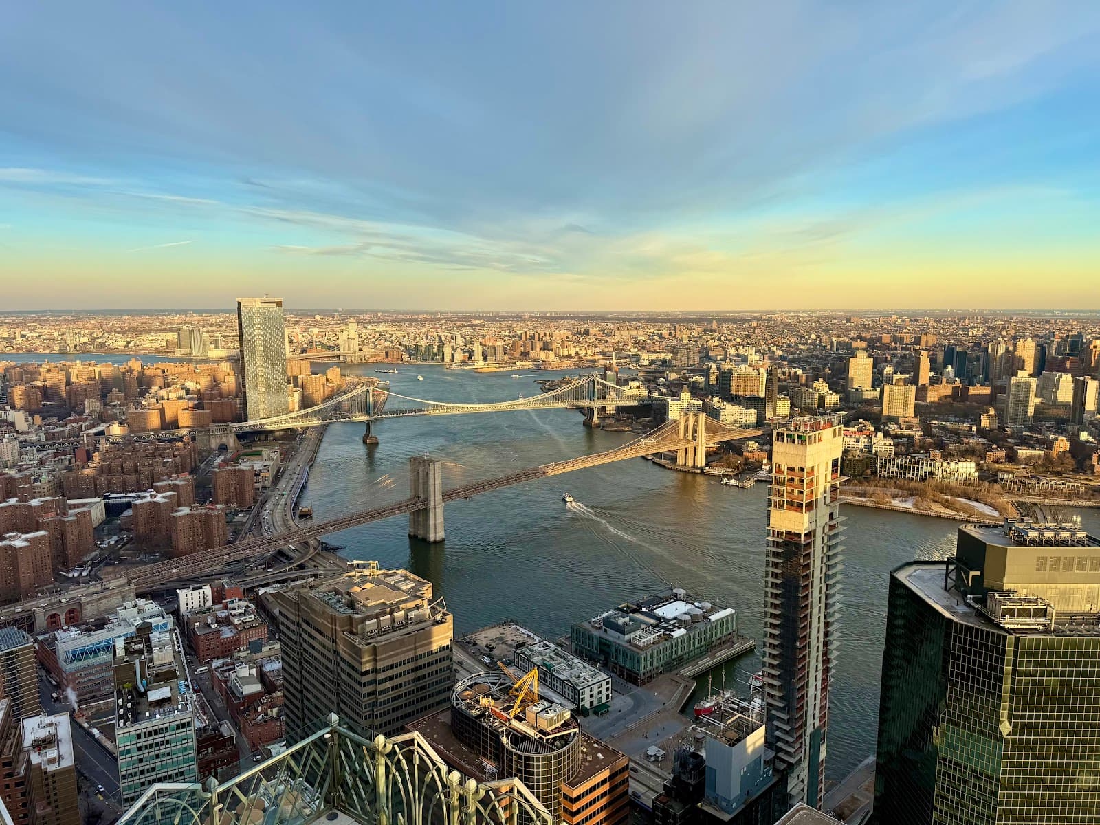 Aerial view of city with bridges crossing a river at dusk in New York