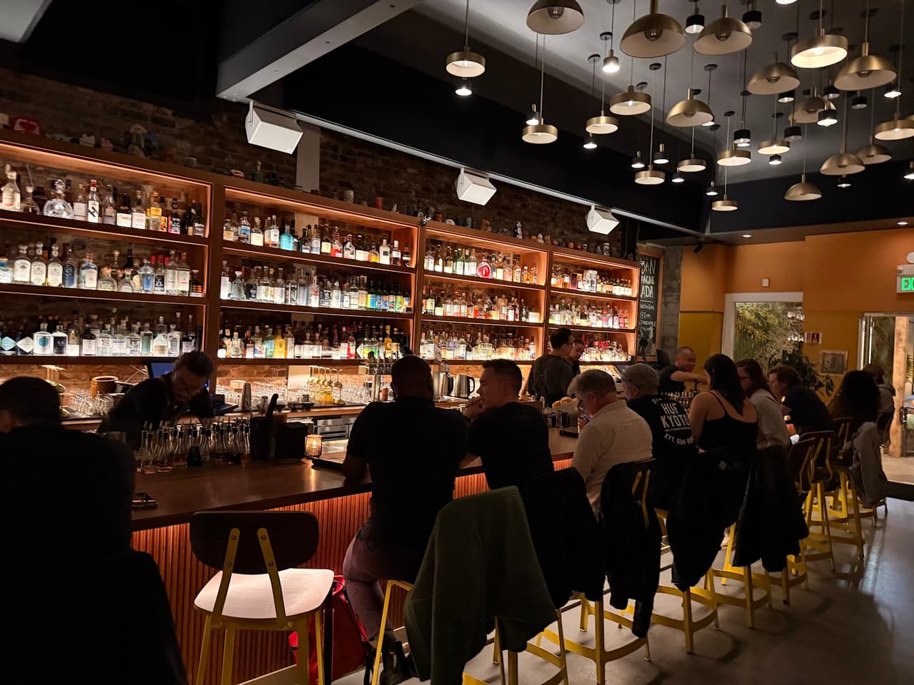 Cozy bar interior with patrons and a stocked back bar in San Francisco
