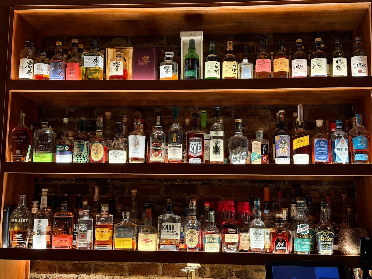 Well-lit bar shelves with a variety of liquor bottles in San Francisco