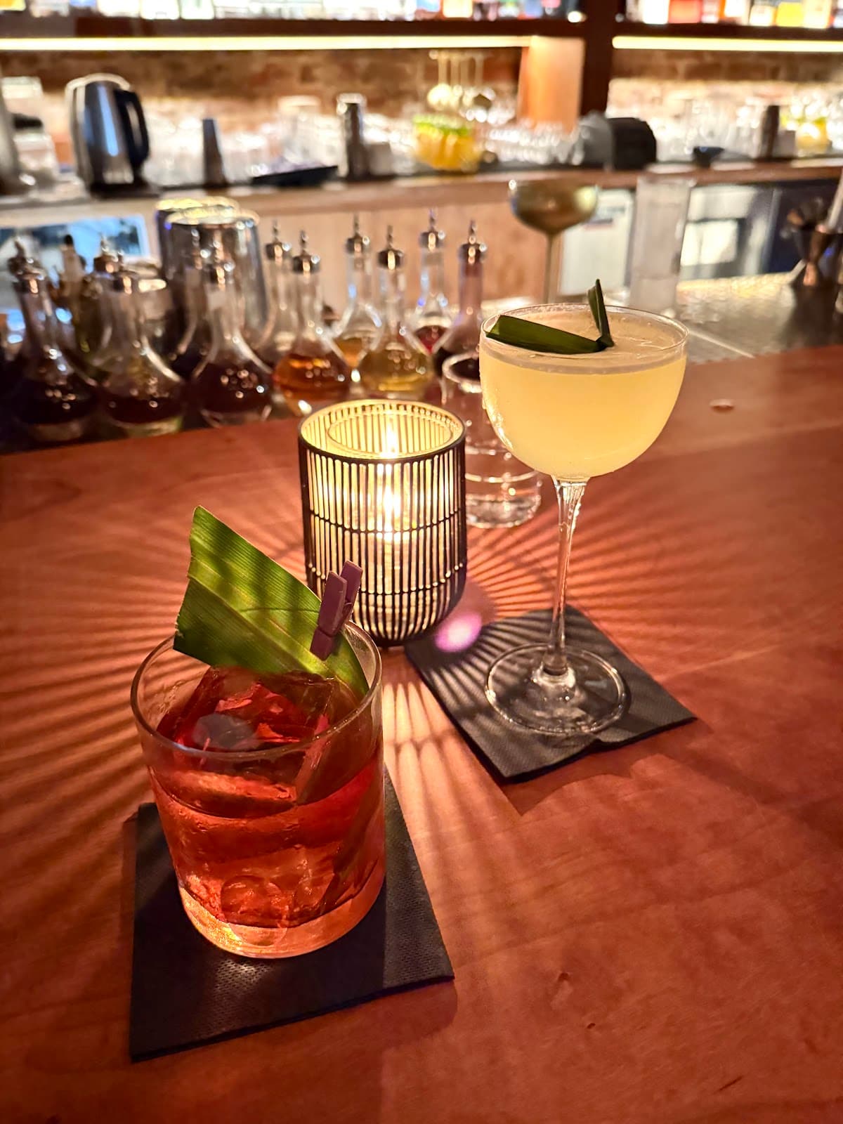 Two cocktails on a bar counter with warm lighting in San Francisco
