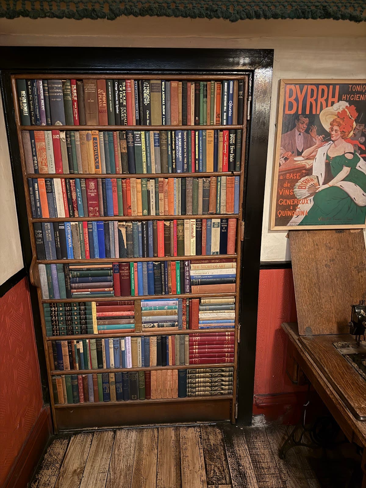 Bookshelf styled as a hidden door in a vintage-themed bar in Edinburgh