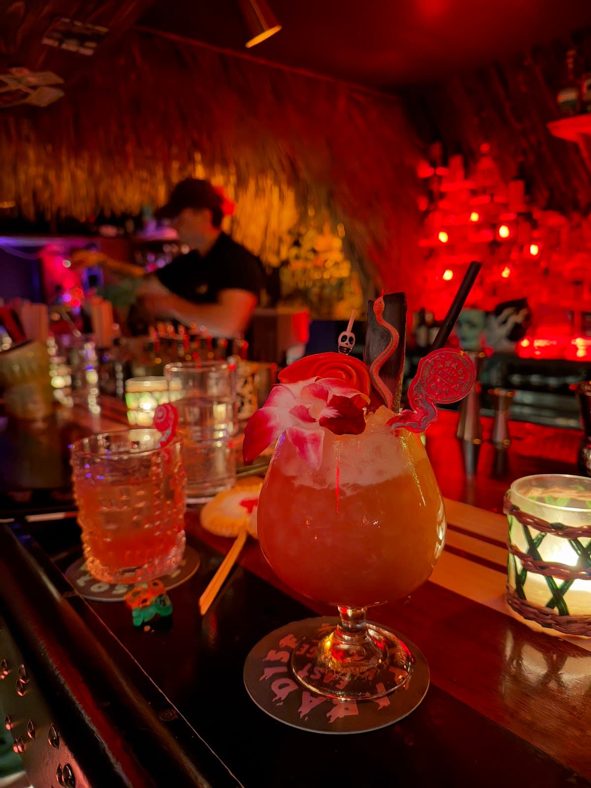 Tropical cocktail with vibrant garnishes on a dimly lit bar counter in New York