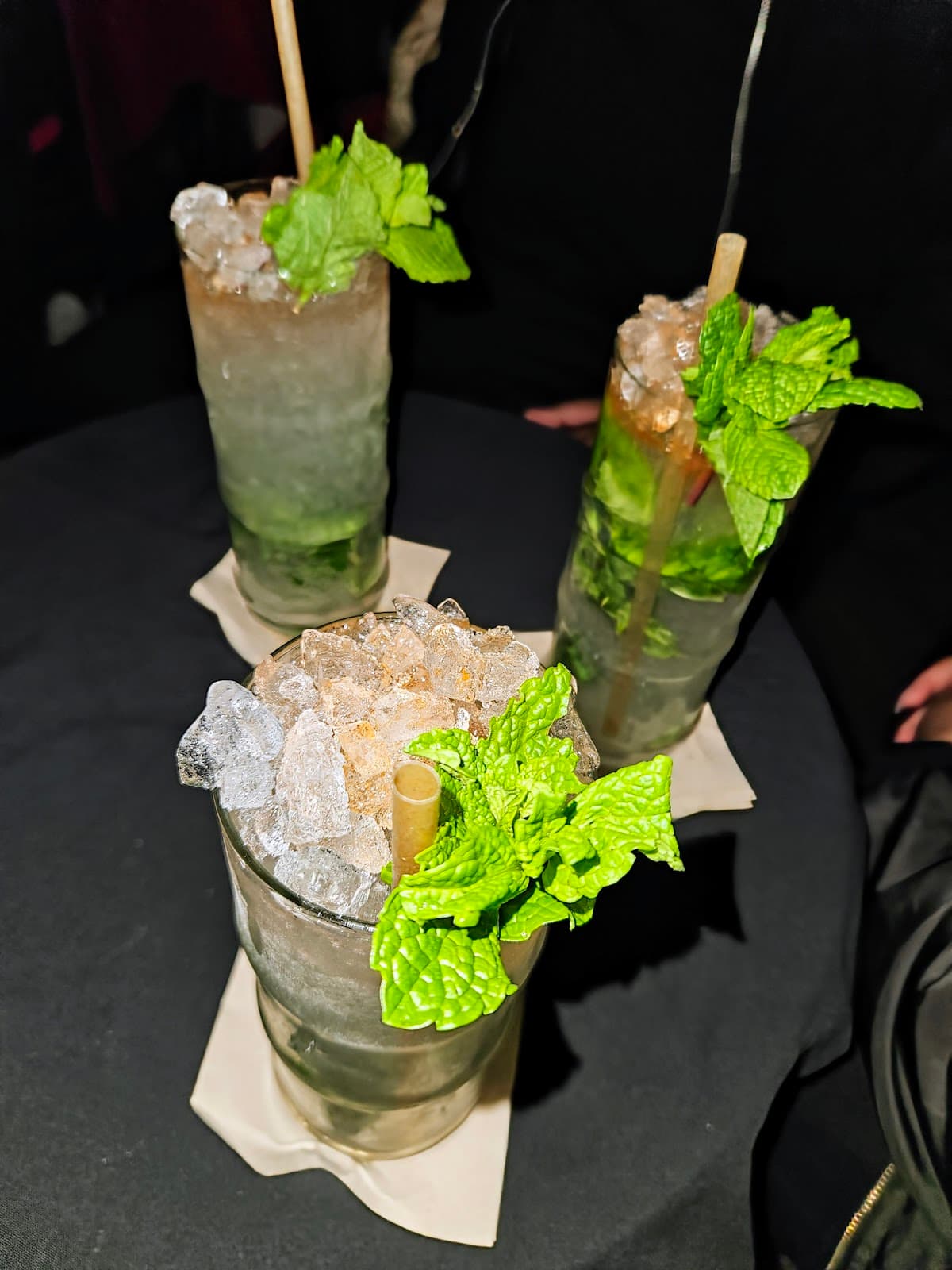 Three mojitos with mint leaves on a dark table in Lisboa
