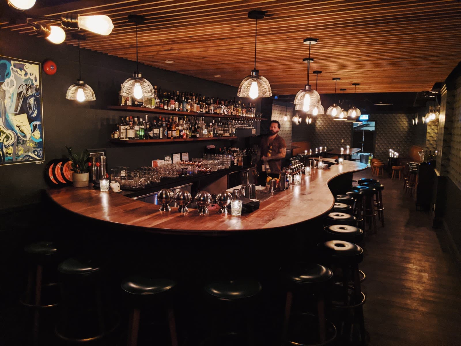Interior bar scene with wooden counter and stylish pendant lights