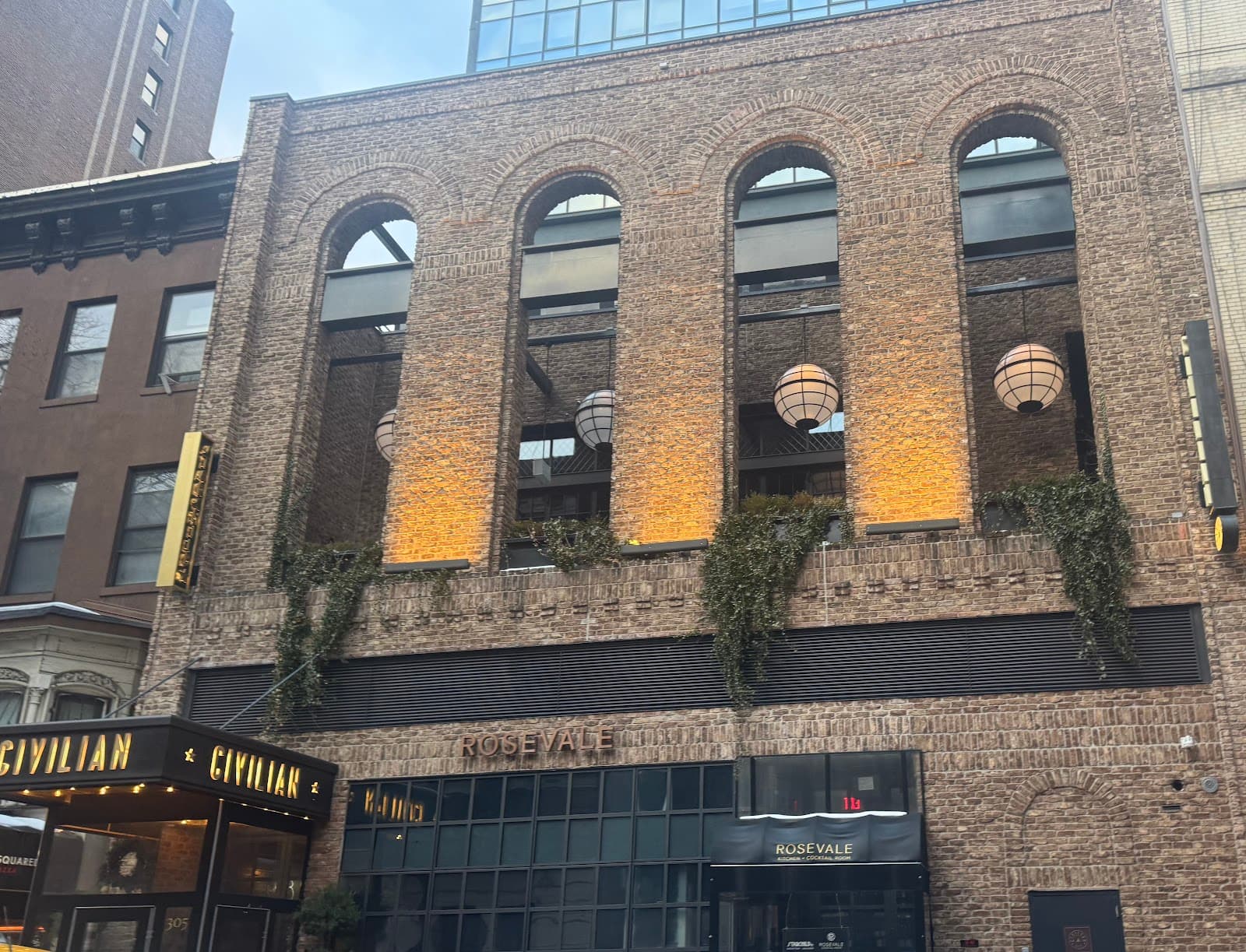 Exterior of Rosevale bar with brick facade and large arch windows in New York
